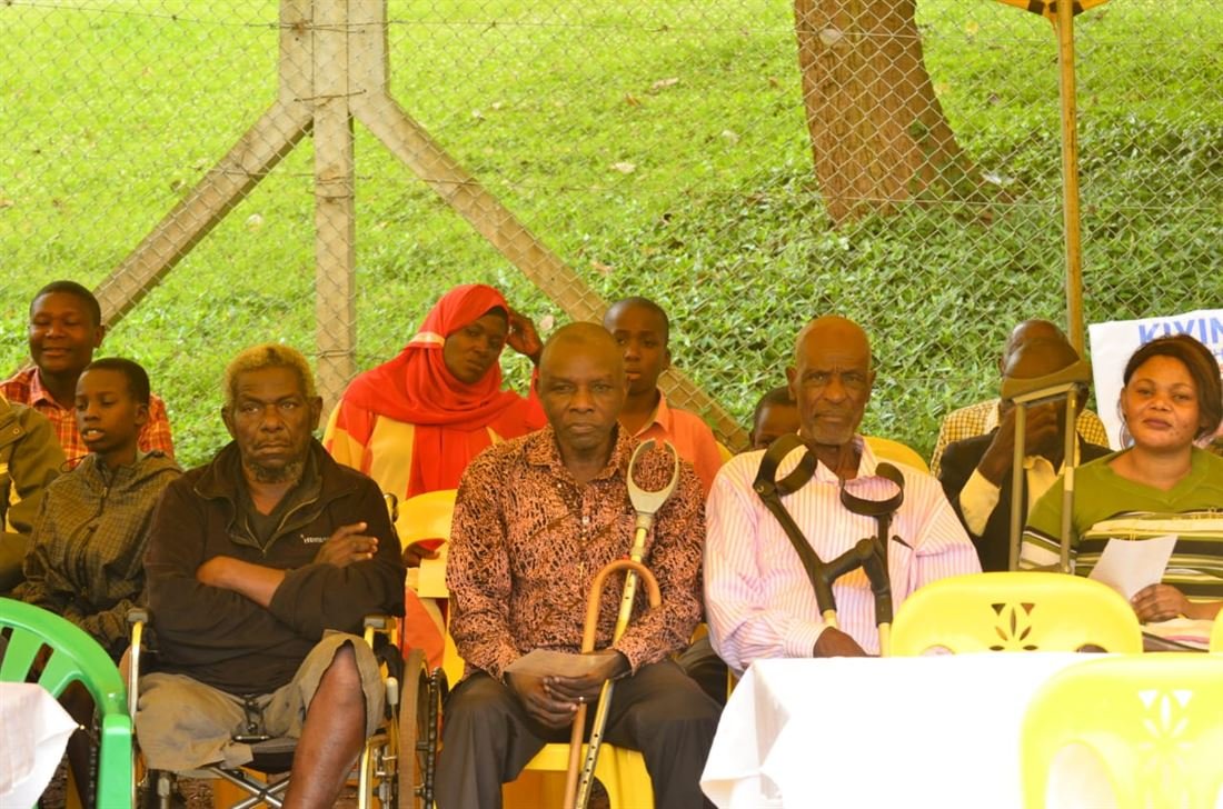 Participants at an RDAF gathering seated together, some with crutches resting beside them.