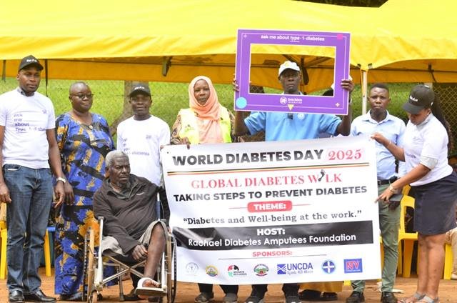 Participants, some using wheelchairs and crutches, gather behind an RDAF event banner.