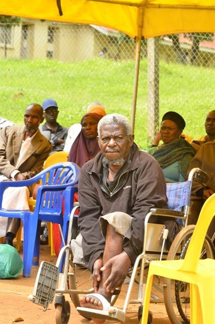 A man seated in a wheelchair among other participants at an RDAF gathering.